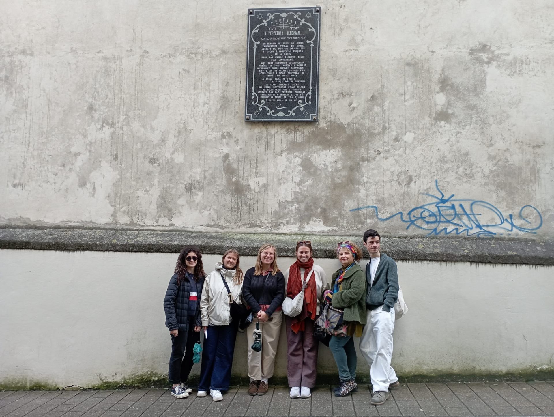 Tour group at Jewish memorial plaque